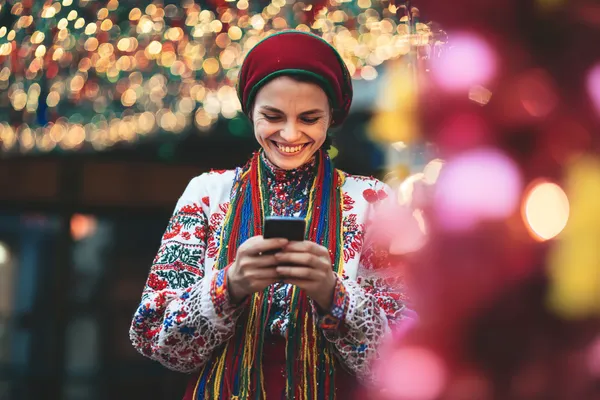 A woman in a luxurious green gown next to an ornate roulette wheel, capturing the upscale casino mood of MASAGANA.